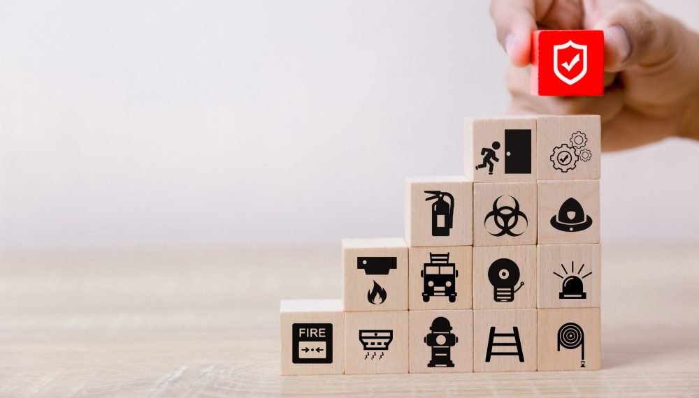 Wooden building blocks with safety symbols on : Health & Safety Consultancy from JCM Health & Safety, Liverpool.