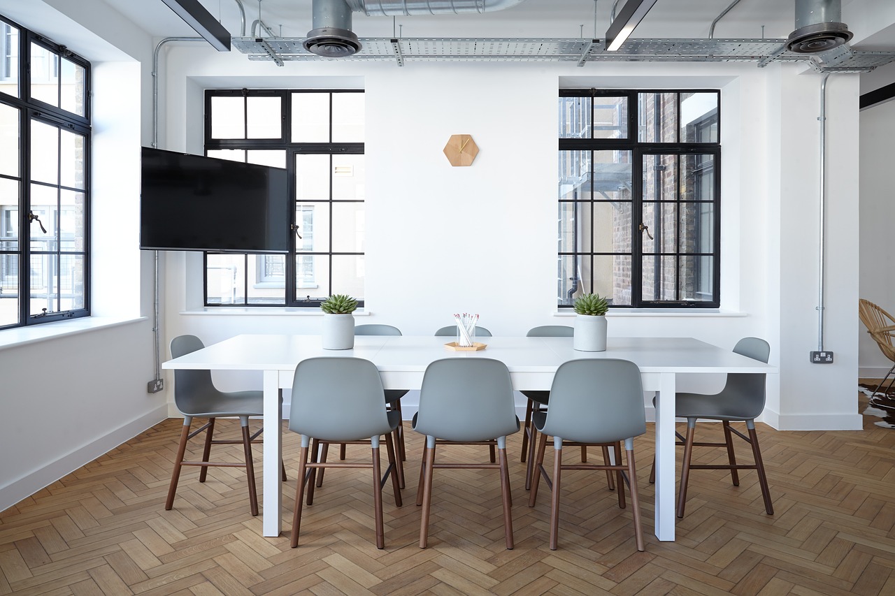 White meeting table with chairs around.